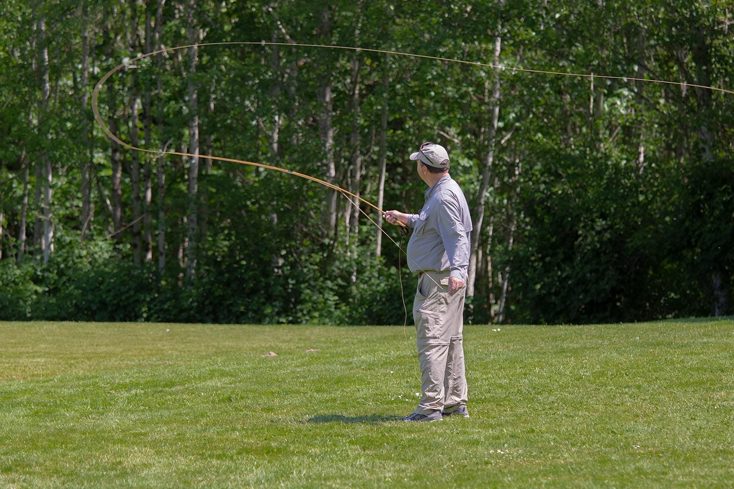 Fly fisherman holding a trout