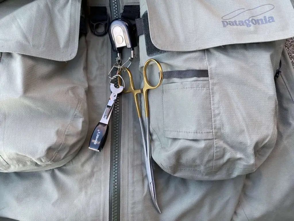 fly fishing pliers on wading jacket