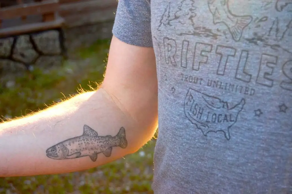 Fly fisherman with tattoo on his arm