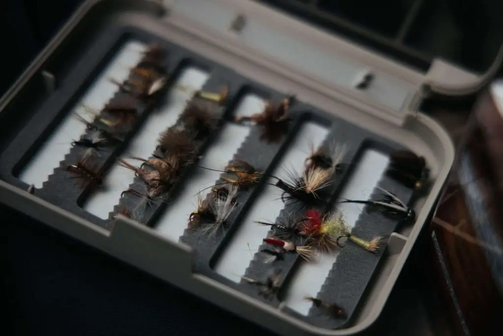 Fly fishing box with flies held by foam slits