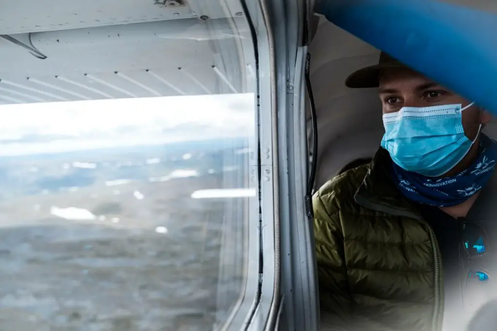 Wearing a mask on a float plane after fishing finnmark