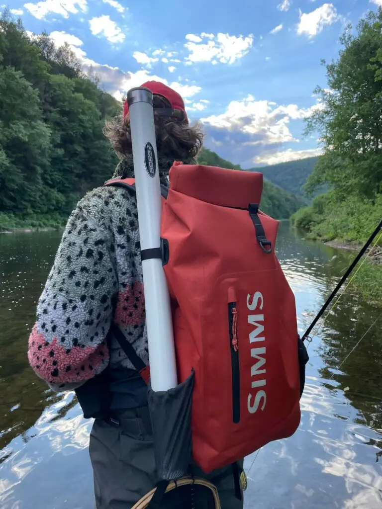 Fly fisherman wearing the Simms Dry Creek Rolltop Backpack