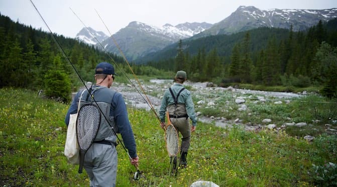 Fly fishermen in the mountains on a stream