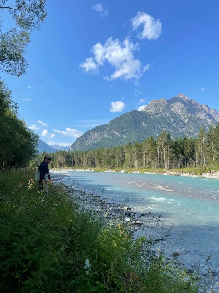 Fly fisherman looking into the water