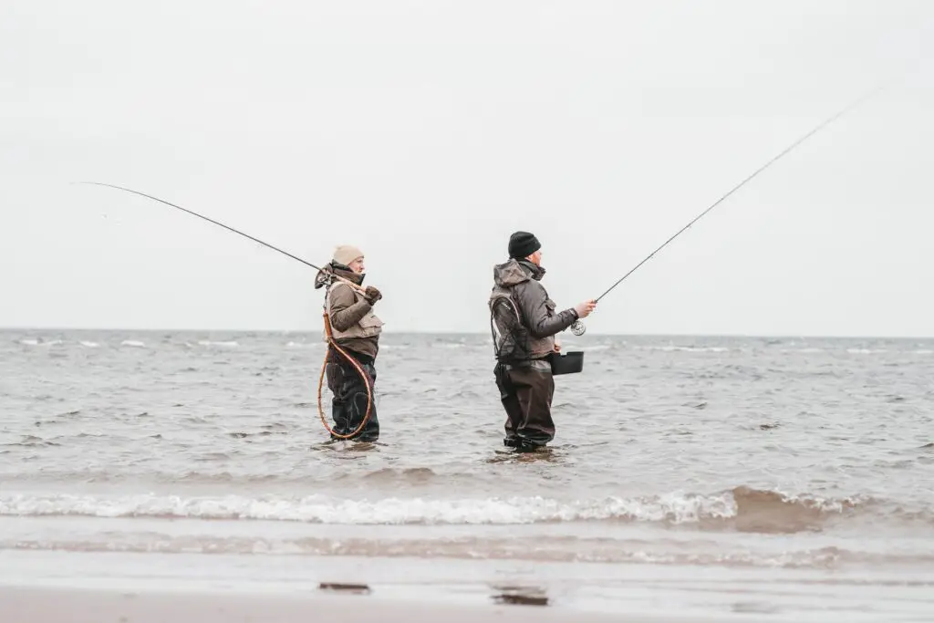 Fly fishermen in the sea wearing waders, wading boots and the best winter wading socks