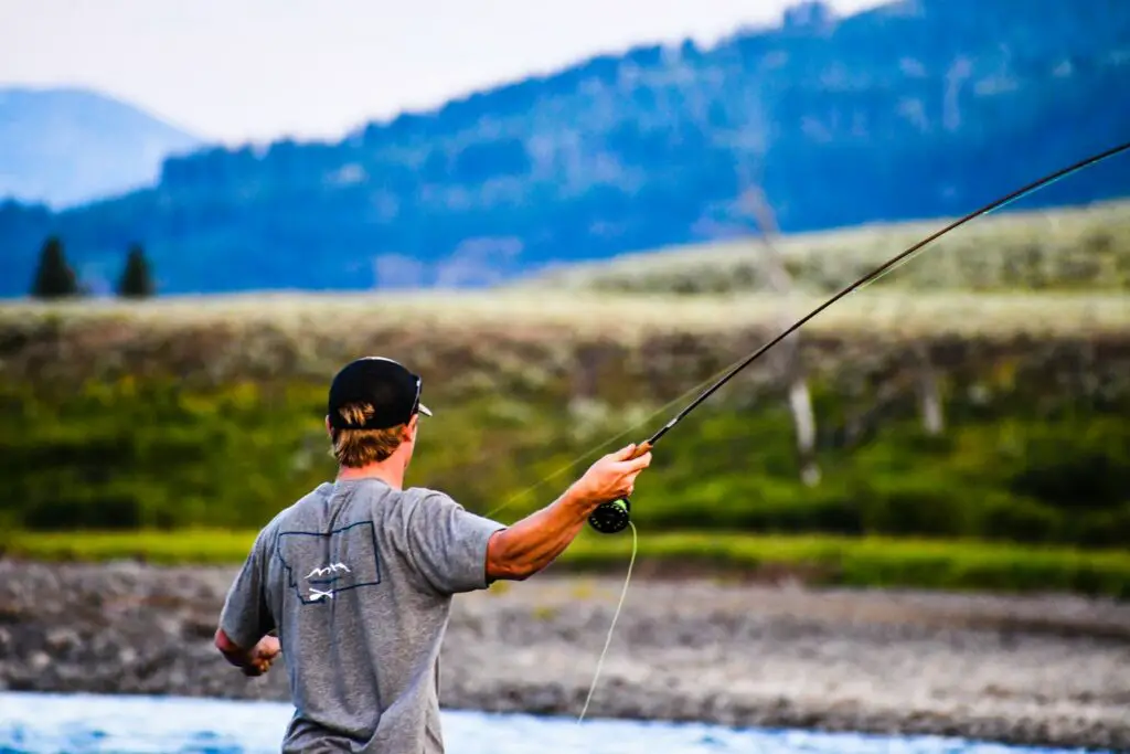 A fly fisherman casting a fly rod 