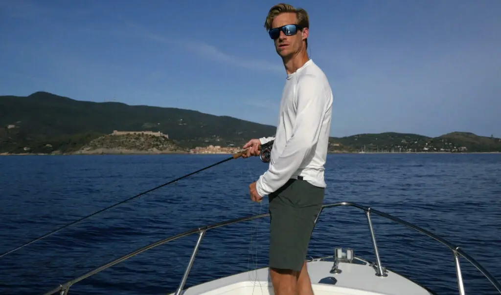 Fly fisherman wearing fishing sunglasses on a boat