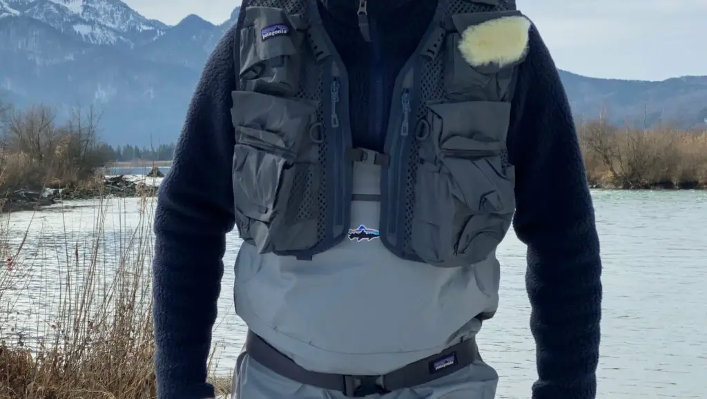 Fly fisherman wearing a fly fishing vest