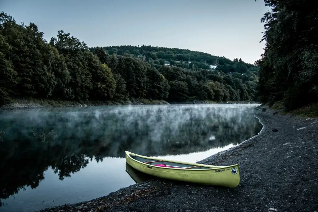 Canoe on river bank - Review of the best fishing canoes