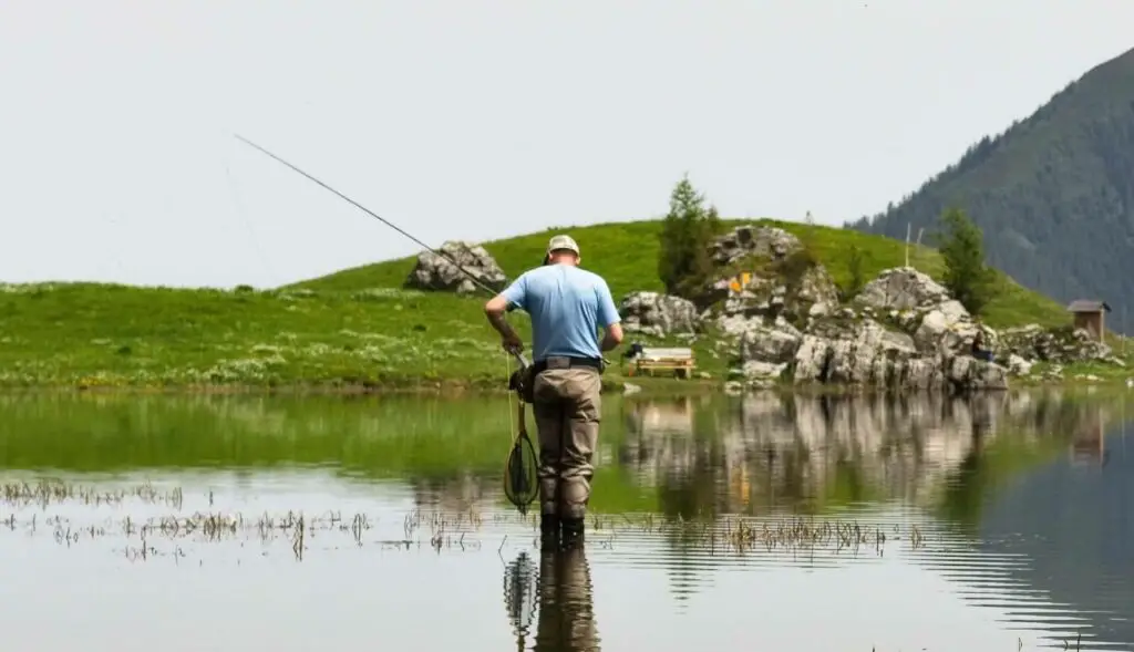 Fly fisherman wearing wader pants: chest waders vs hip waders guide