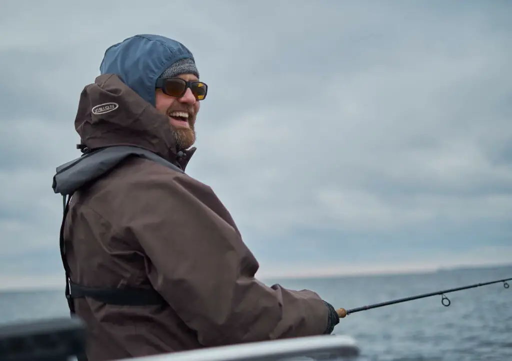 Fly fisherman casting to sea trout in the Baltic Sea