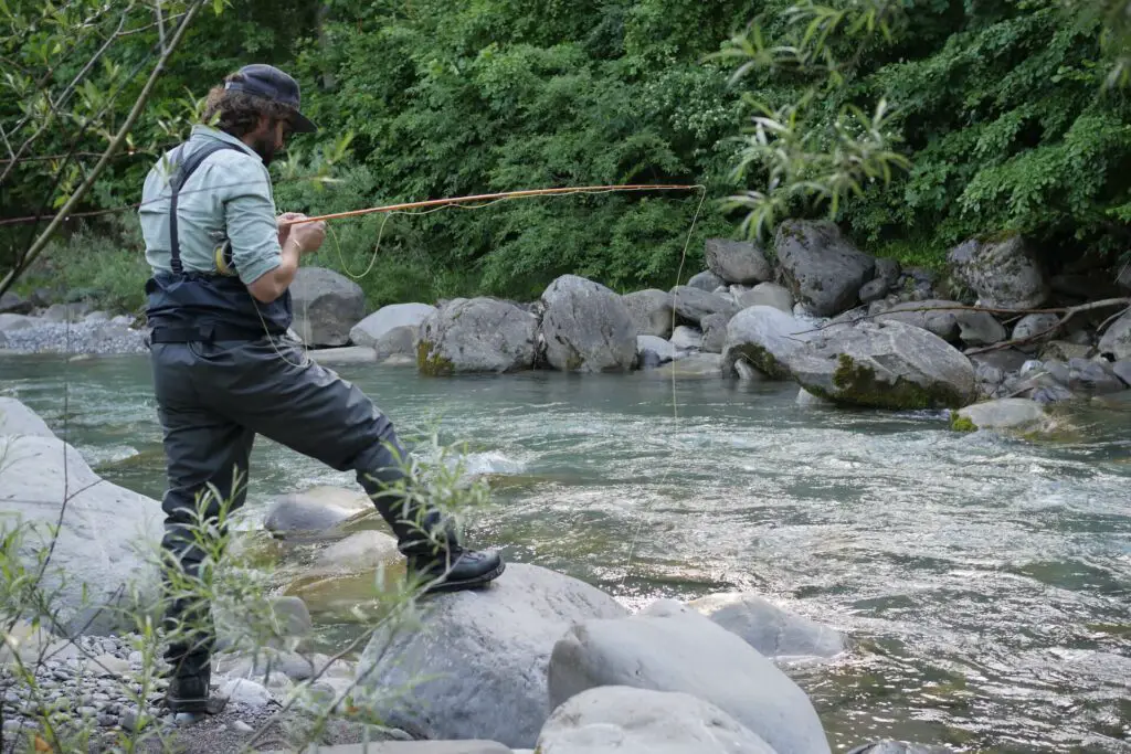 Fly fisherman wearing a longsleeve fishing shirt