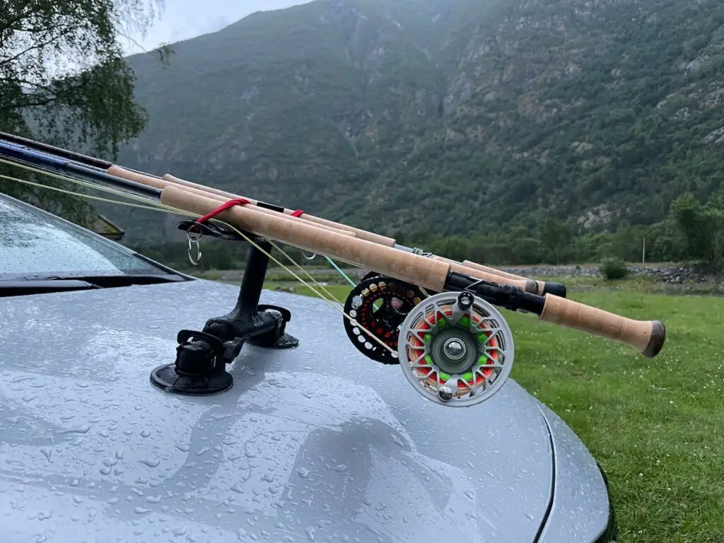 Fly reels on a rod holder on a car