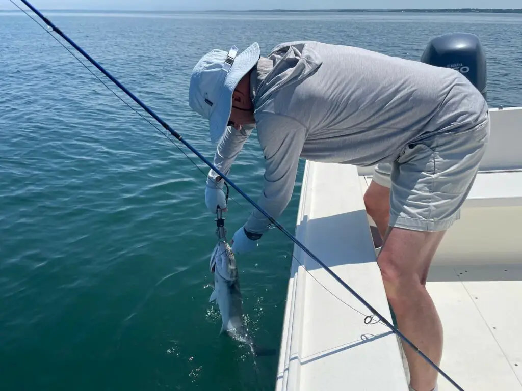 Fly Fisherman on boat wearing fishing shorts