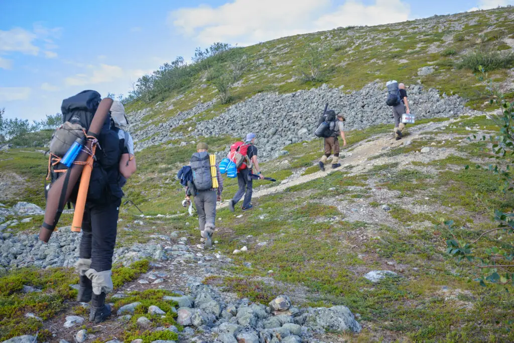 Fly fishermen walking up a hill