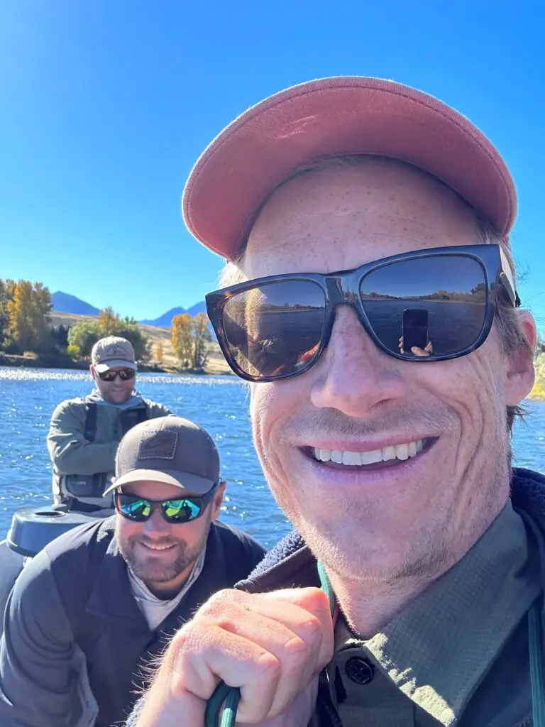 Fly fishermen on a drift boat wearing polarized sunglasses for fishing