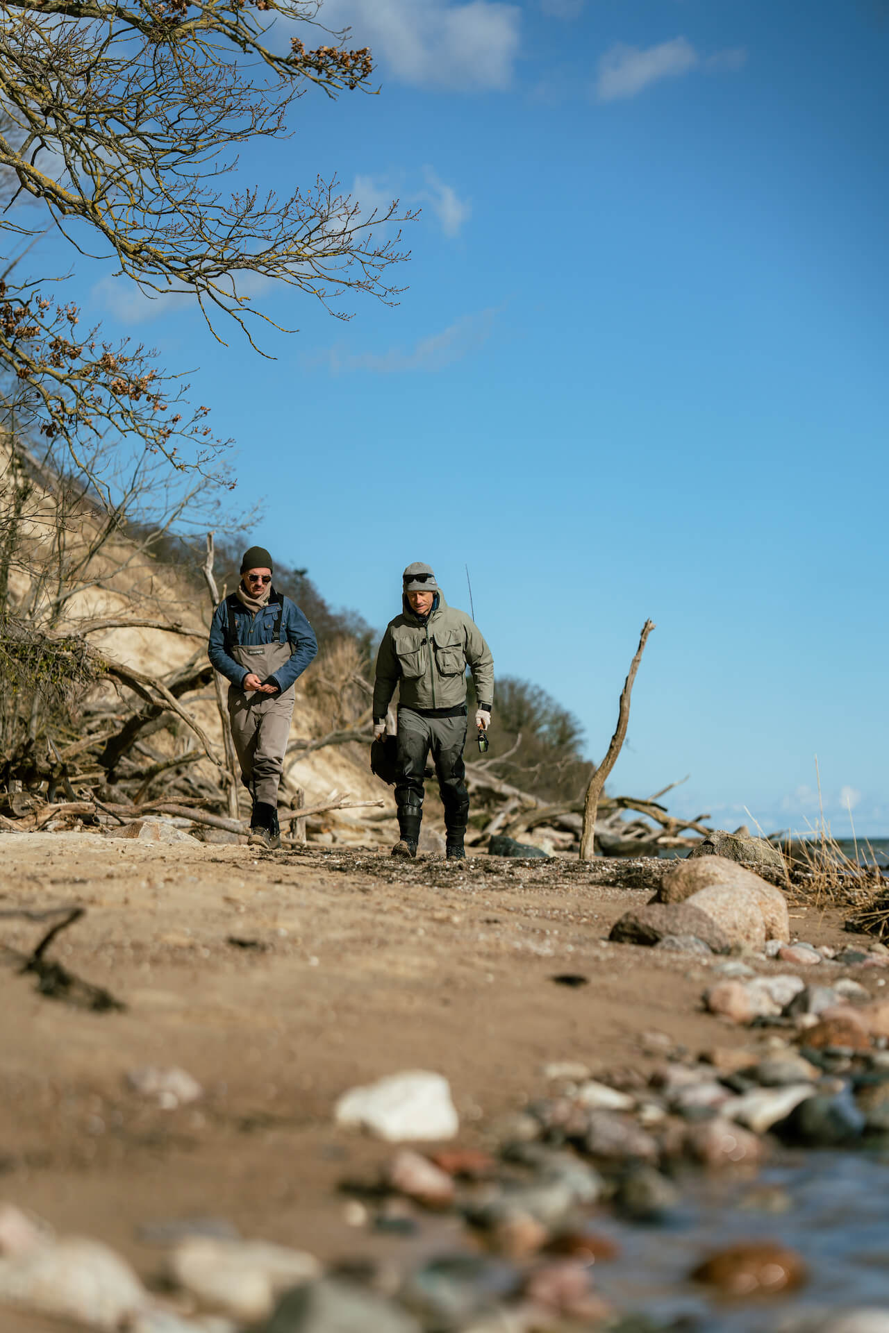 Fly fishermen walking along the shore