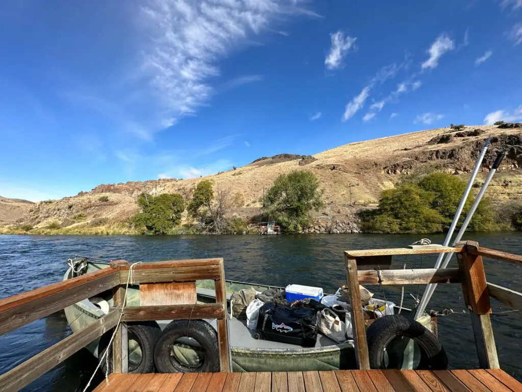 Patagonia Black Hole Wheeled Duffel Bag on a boat on the Deschutes River