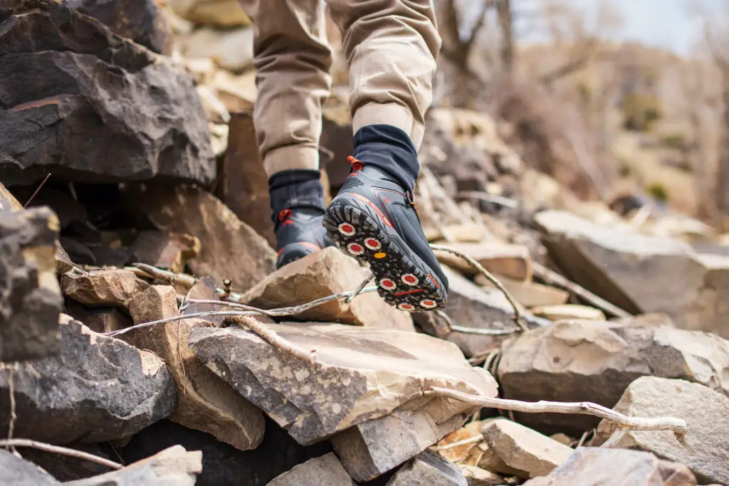 Simms G4 Wading Boots on rocky river bank