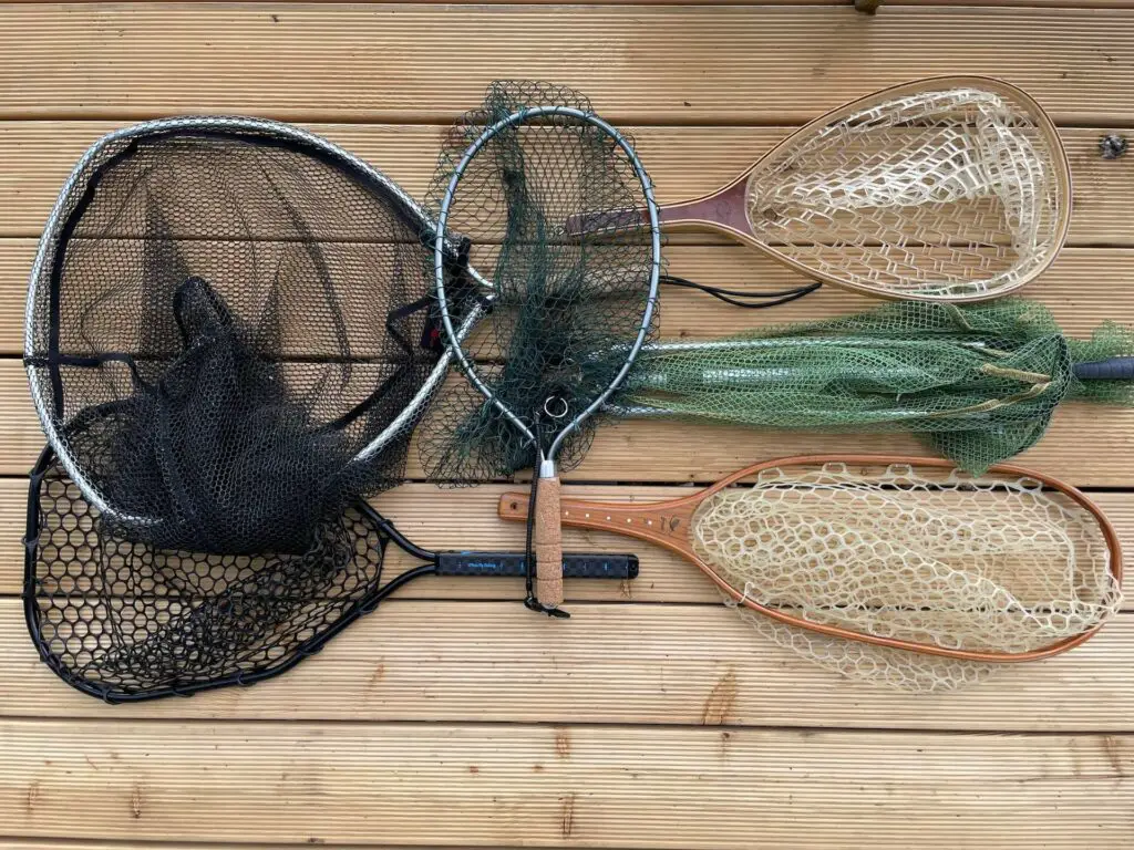 Fly Fishing nets of different shapes and sizes on a wooden floor