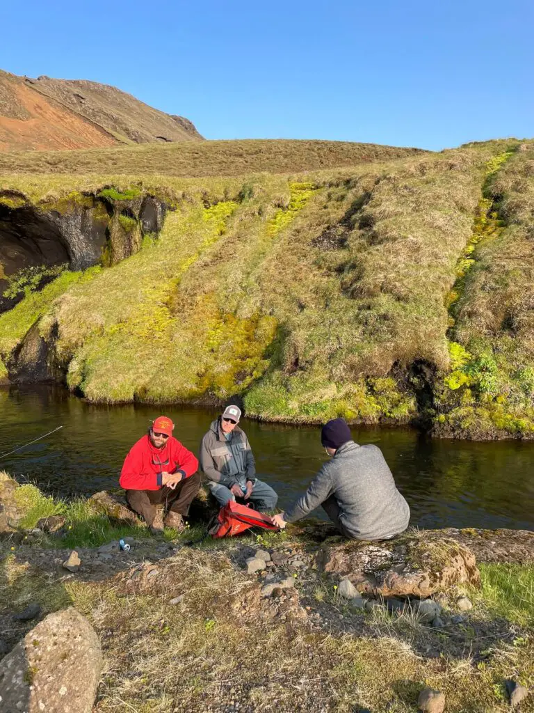 Fly fishermen on a river bank