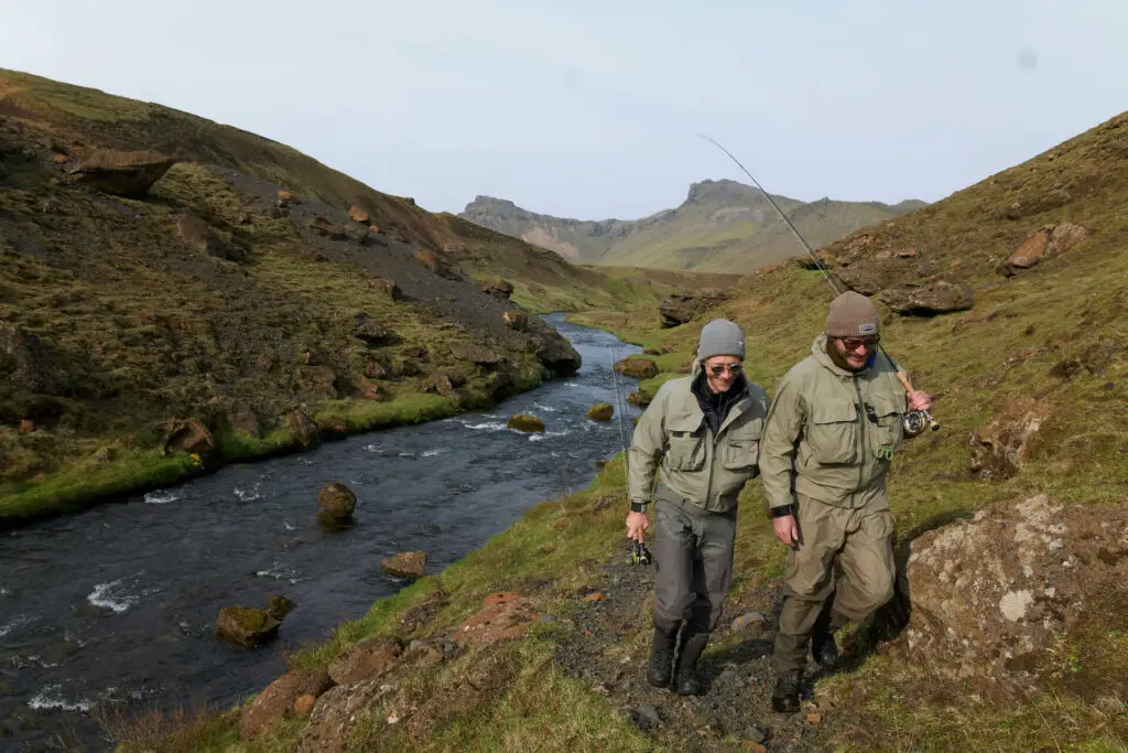 Fly fishermen in Iceland walking along a river