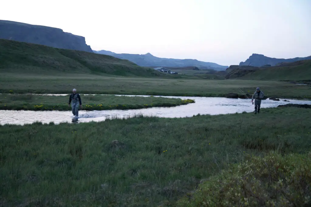 Fly fishermen in Iceland wading a river