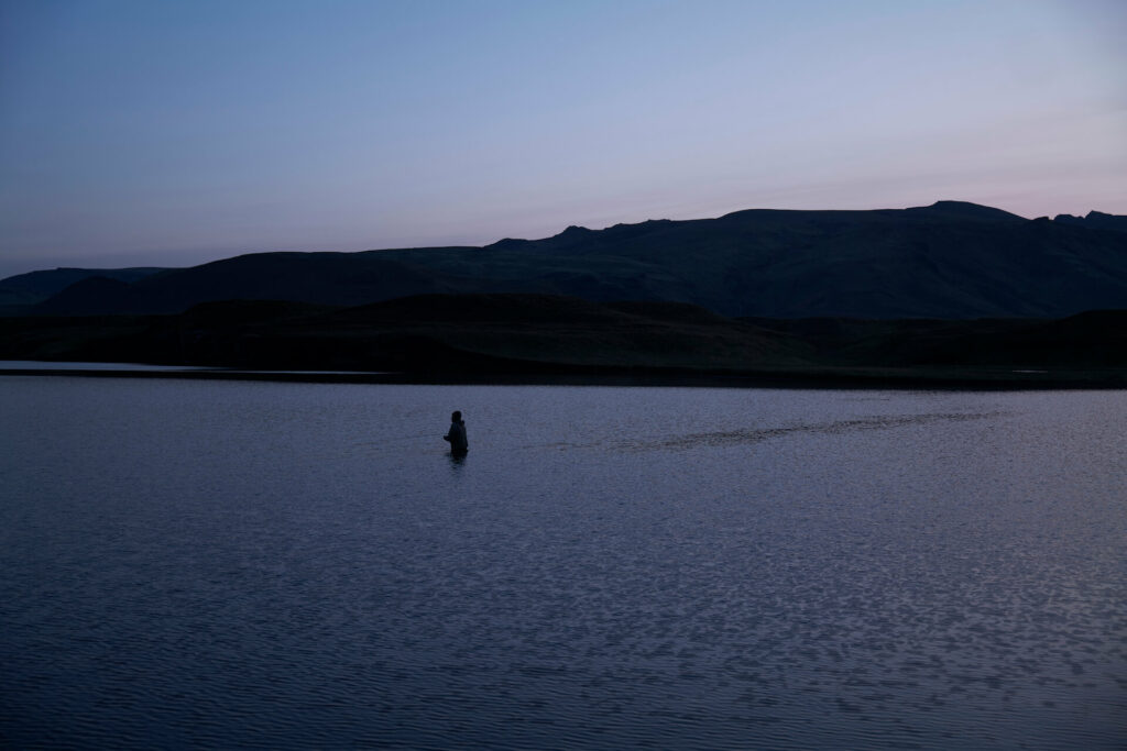 A fly fisherman fishes the lake at Heidarvatn, Iceland. 