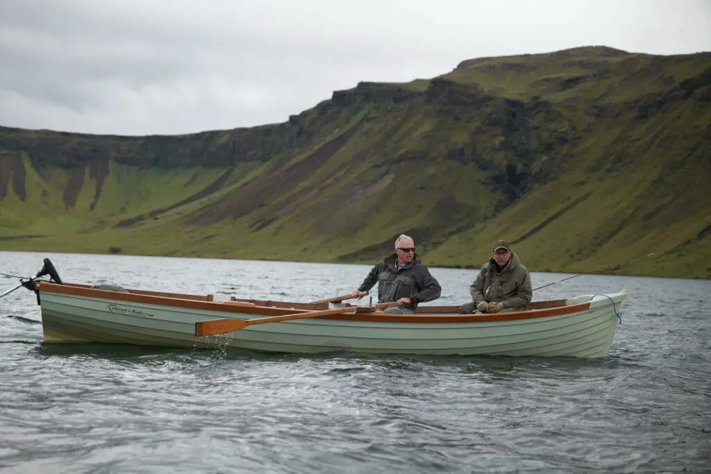 fly fishermen in a boat on a lake