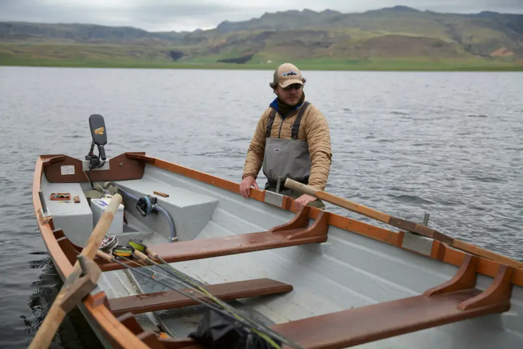 Fly fisherman with a boat