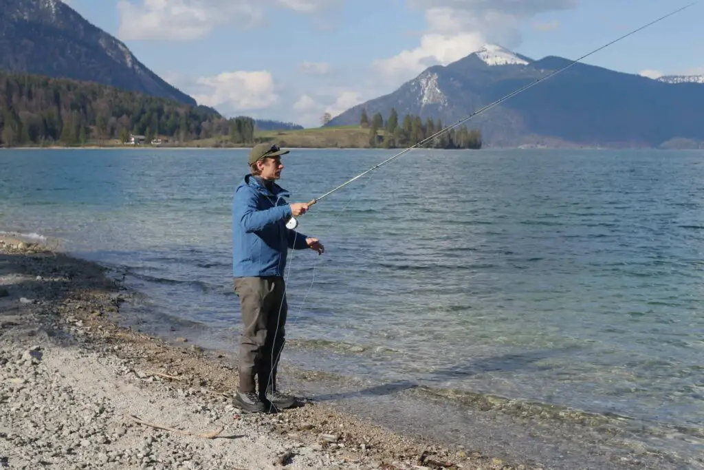 Fly fisherman casting a fly rod wearing the Simms Fishing M's G3 Guide Stockingfoot Waders