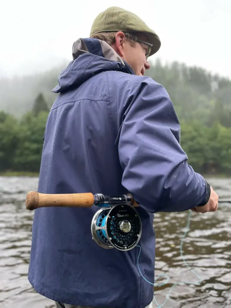 Fly fisherman fishing for salmon wearing a premium wading jacket