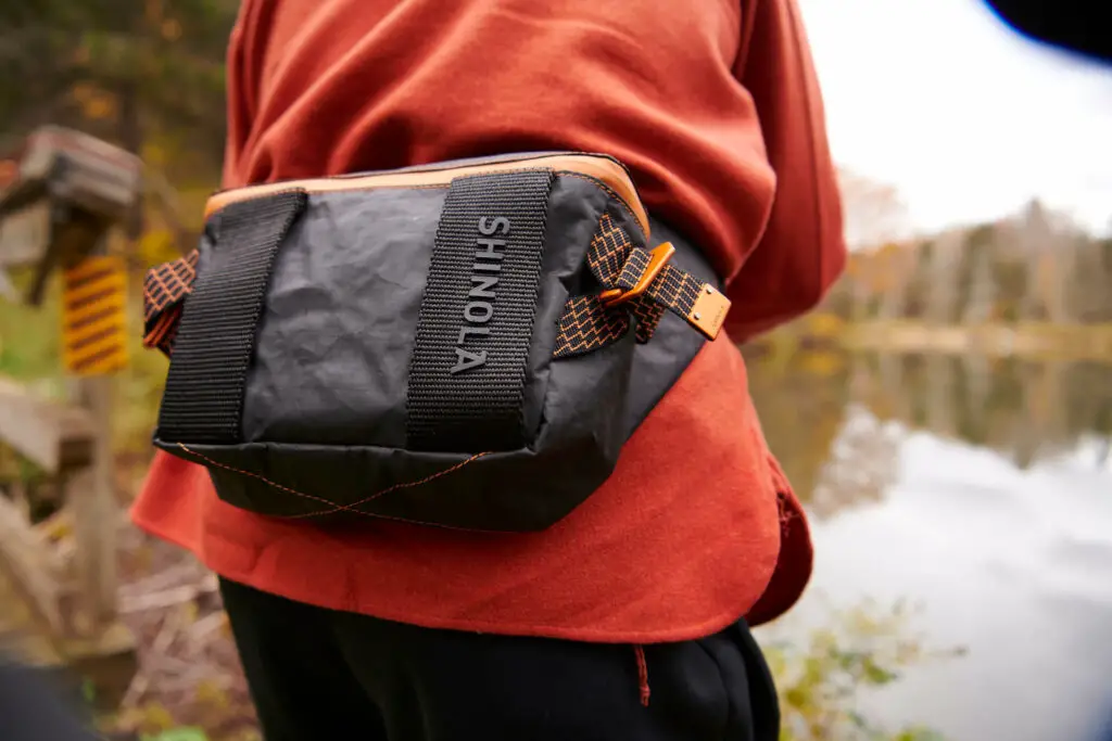 The 10,000 Mile Bag by Shinola Detroit worn by a fly fisherman