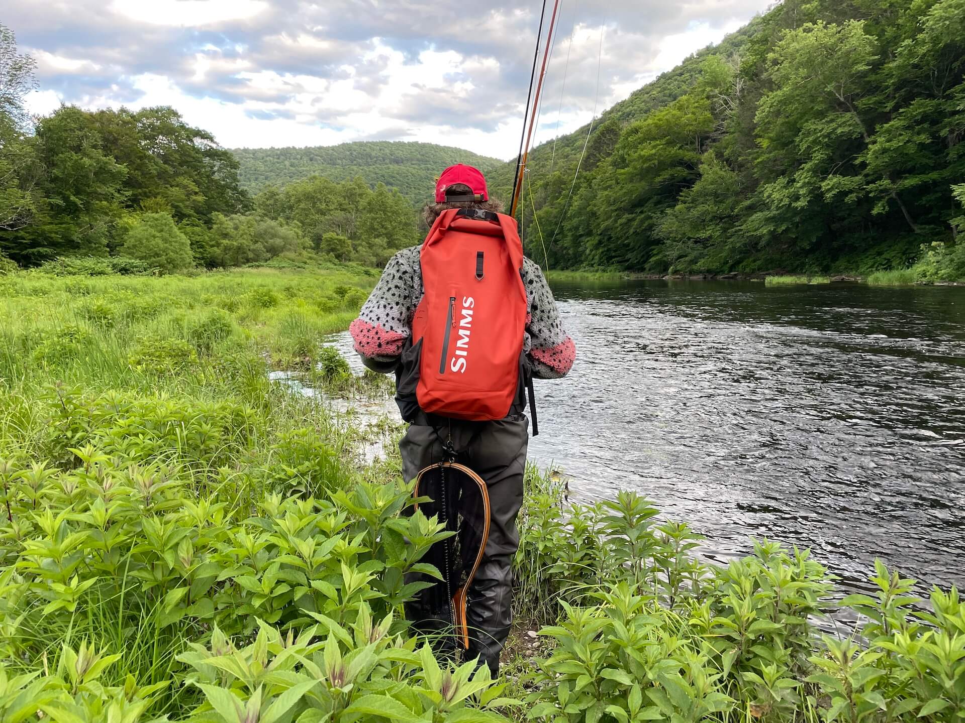 Fly fisherman carrying a backpack