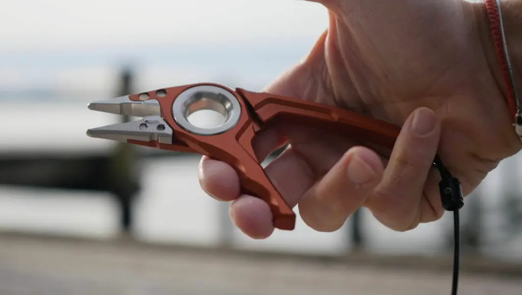 Simms Flyweight Plier in the hands of a fisherman