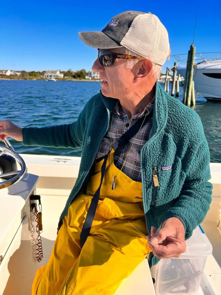 Fly fisherman wearing the Suncloud Boone sunglasses on a boat