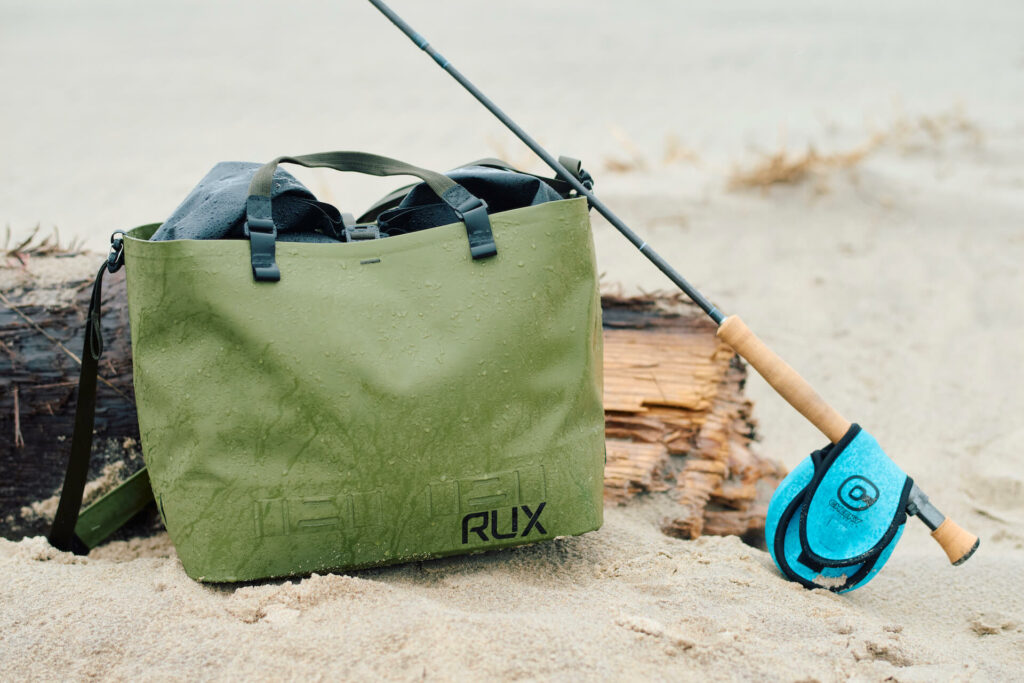 Rux Waterproof Bag with fly rod in the sand