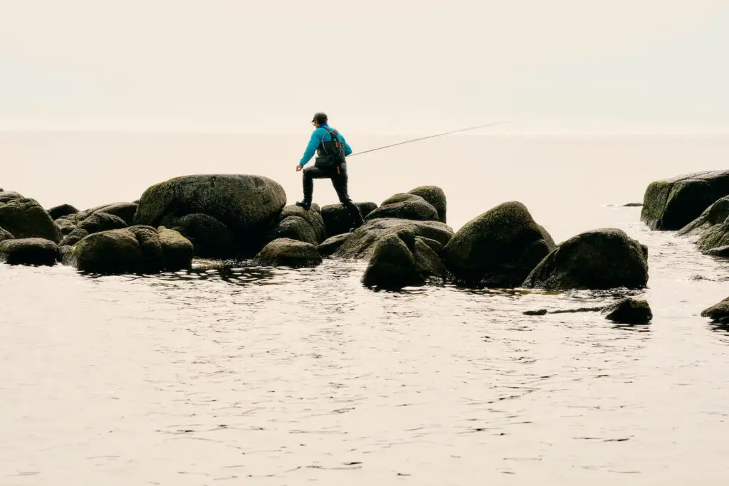 Fly fisherman wearing the YETI Sidekick while wading in the water