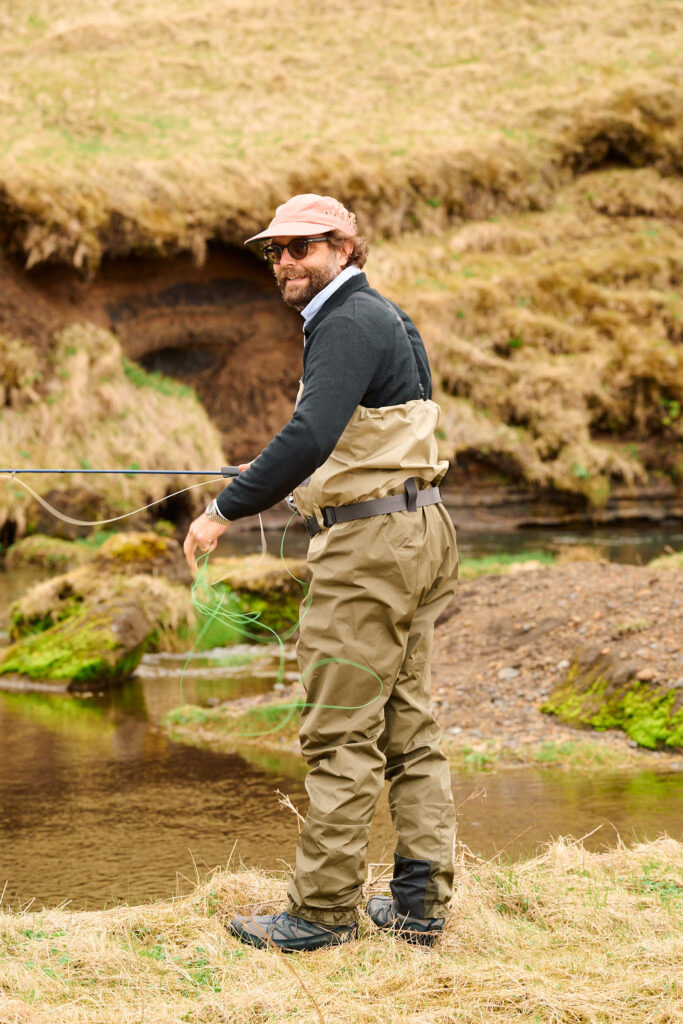 Fly fisherman by the river wearing the new Patagonia Swiftcurrent waders