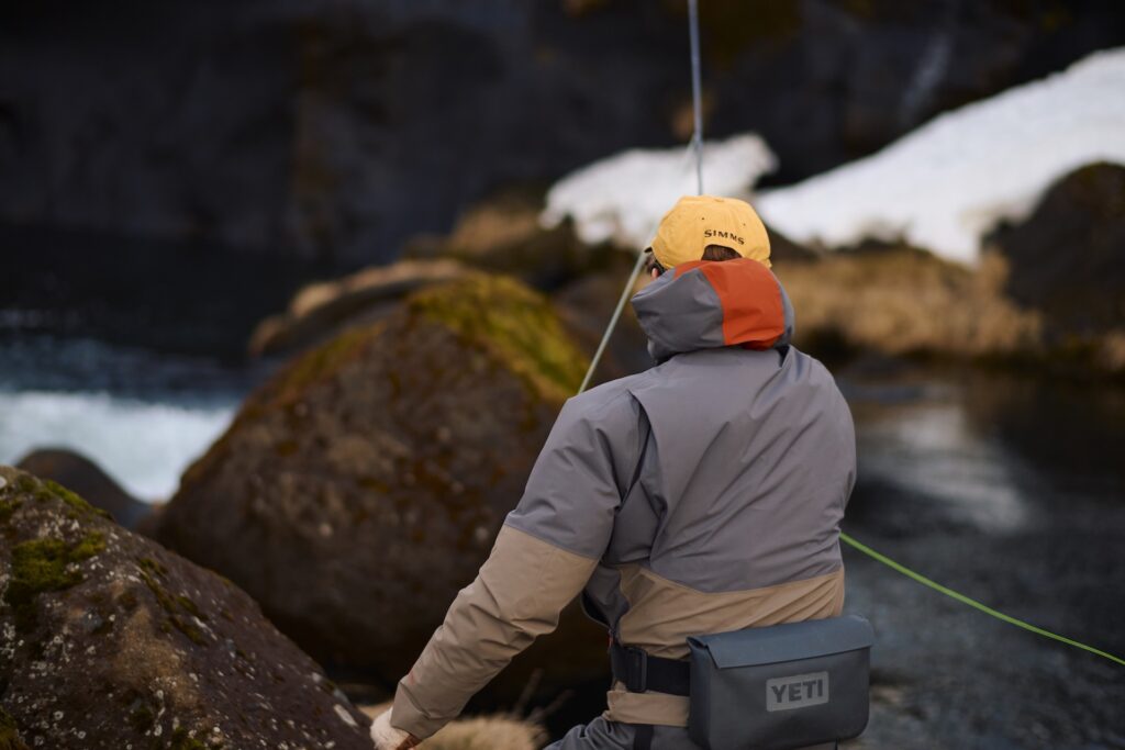 Fly fisherman casting a rod