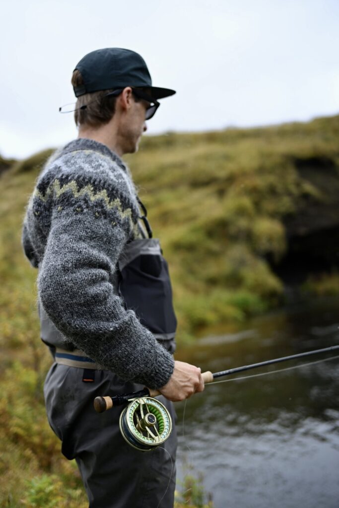 Guideline Fario Fly Reel in hand of fly fisherman