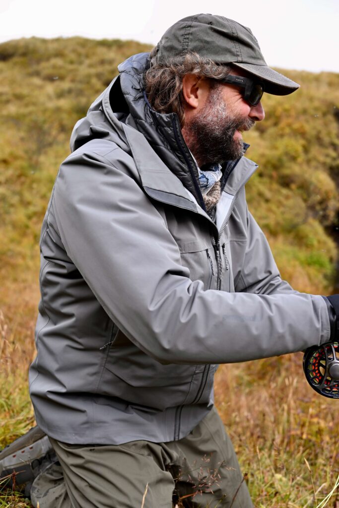 Fly fisherman wearing the Patagonia Swiftcurrent Jacket